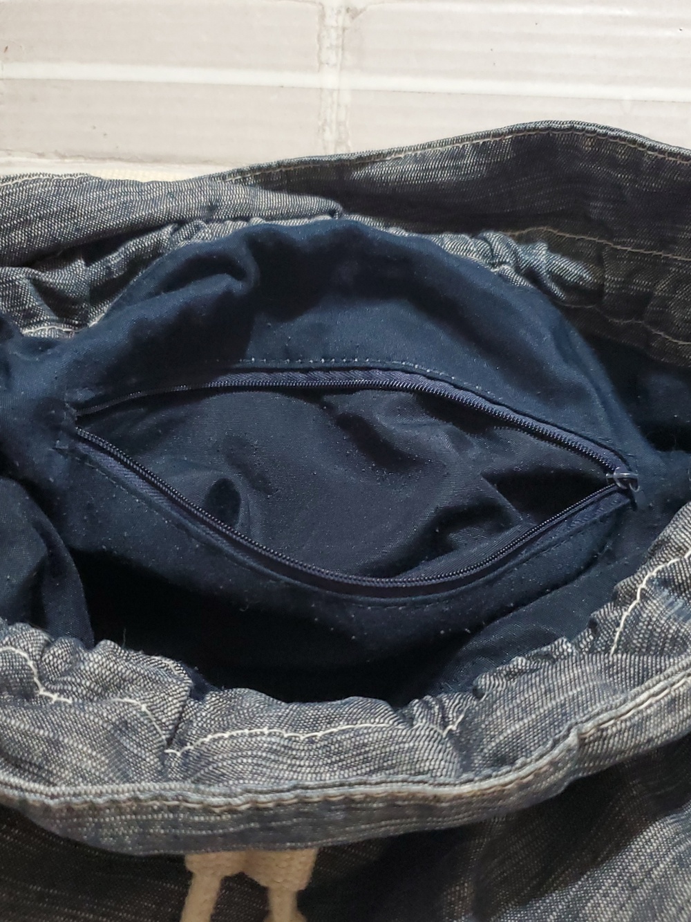 Denim-Look Drawstring Backpack with Cream Strap Details - Picture 11 of 12